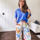 Textured ocean blue puff sleeve top with scalloped hem and mock neck with V neck front.
