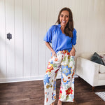 Textured ocean blue puff sleeve top with scalloped hem and mock neck with V neck front.