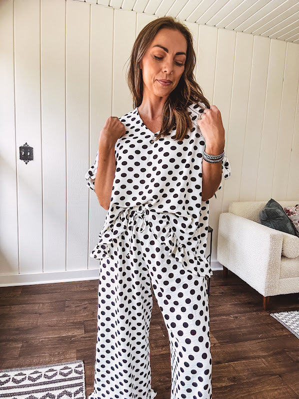 Lightweight, flowy wide leg pants with elastic drawstring waist and ruffled cuffs.