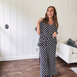 Lightweight white or black short sleeved top with black or white polka dots throughout with V neck, short ruffled sleeves and ruffled hem.