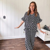 Lightweight white or black short sleeved top with black or white polka dots throughout with V neck, short ruffled sleeves and ruffled hem.