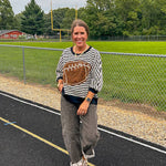 Soft, terry-like black and white striped half sleeve top with oversized leopard print football applique on the front, black trim at the round neck, cuffs and wide hem.