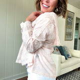 Sheer button front tone on tone floral embroidery top with scalloped trim, long sleeves and hoodie.