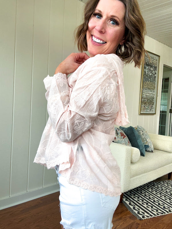 Sheer button front tone on tone floral embroidery top with scalloped trim, long sleeves and hoodie.