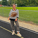 Soft, terry-like black and white striped half sleeve top with oversized leopard print football applique on the front, black trim at the round neck, cuffs and wide hem.