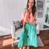 Washed teal wide leg utility pants with a raw hem and elastic drawstring waist.