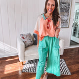 Washed teal wide leg utility pants with a raw hem and elastic drawstring waist.