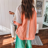 Salmon colored 3/4 sleeve blouse with striped blue and brown yarn collar, three wooden buttons on front, relaxed fit and mesh at the shoulders and sleeves.