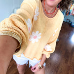 Soft, lightweight, nearly sheer knit pullover  with long sleeves, exposed seams at the shoulders and down the center with large daisy florals throughout. Available in multiple colors.