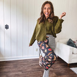 Lightweight denim-like non-stretch wide leg pants with elastic back waist, side and back pockets, button and zipper closure and black and cream stripes on one leg and funky leopard, heart, eye graphics on a black background on the other.