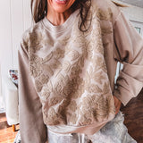 Taupe crew neck pullover with matching floral embroidery on the front.