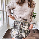 Camo terry knit mini skirt with crochet patchwork, drawstring waist, side pockets an zipper pocket.