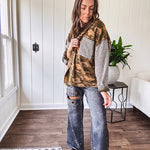 Lightweight button front camo jacket with olive and mustard colorway textured waffle weave on the sleeves and pockets, collar, metal buttons and tiny floral rivets throughout.