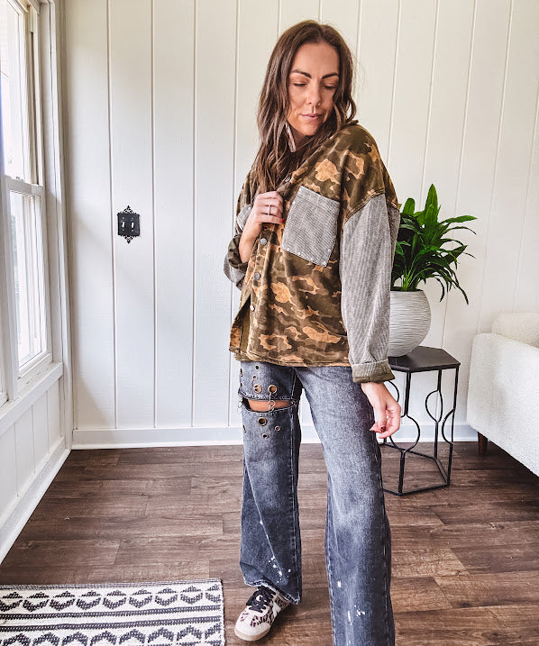 Lightweight button front camo jacket with olive and mustard colorway textured waffle weave on the sleeves and pockets, collar, metal buttons and tiny floral rivets throughout.