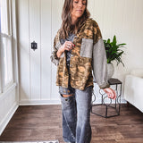 Lightweight button front camo jacket with olive and mustard colorway textured waffle weave on the sleeves and pockets, collar, metal buttons and tiny floral rivets throughout.