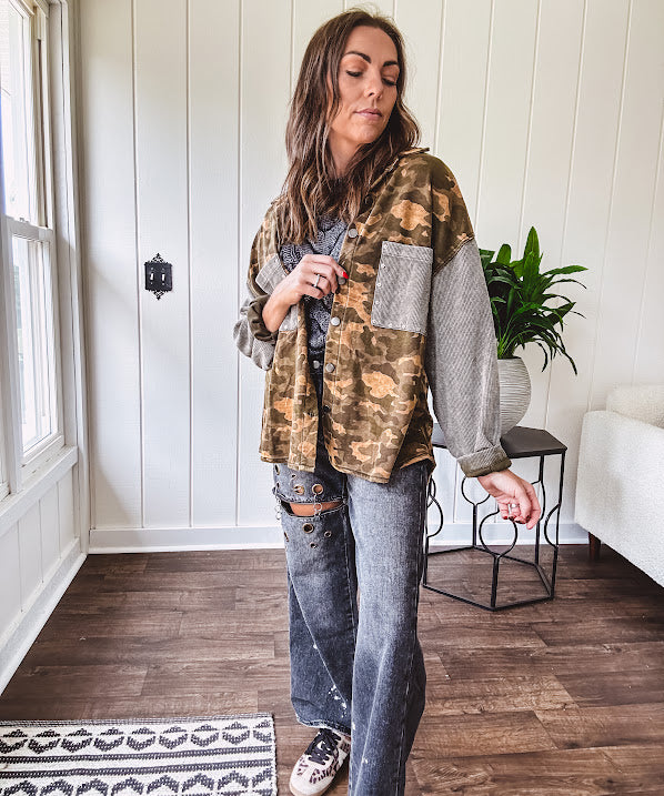 Lightweight button front camo jacket with olive and mustard colorway textured waffle weave on the sleeves and pockets, collar, metal buttons and tiny floral rivets throughout.
