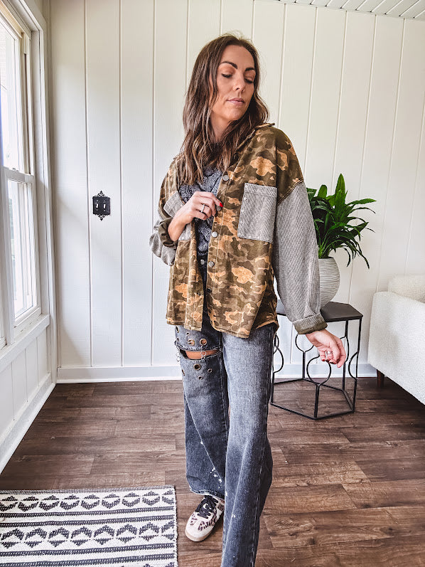Lightweight button front camo jacket with olive and mustard colorway textured waffle weave on the sleeves and pockets, collar, metal buttons and tiny floral rivets throughout.