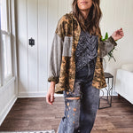 Lightweight button front camo jacket with olive and mustard colorway textured waffle weave on the sleeves and pockets, collar, metal buttons and tiny floral rivets throughout.