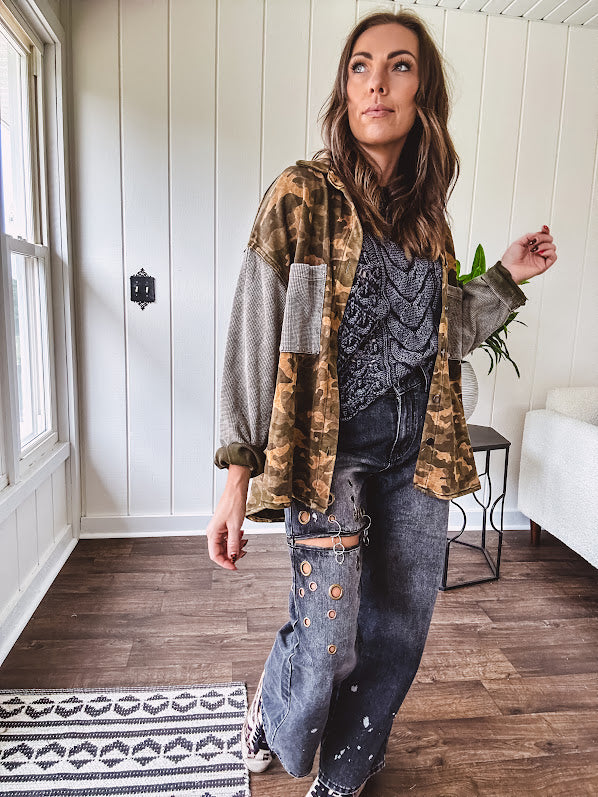 Lightweight button front camo jacket with olive and mustard colorway textured waffle weave on the sleeves and pockets, collar, metal buttons and tiny floral rivets throughout.