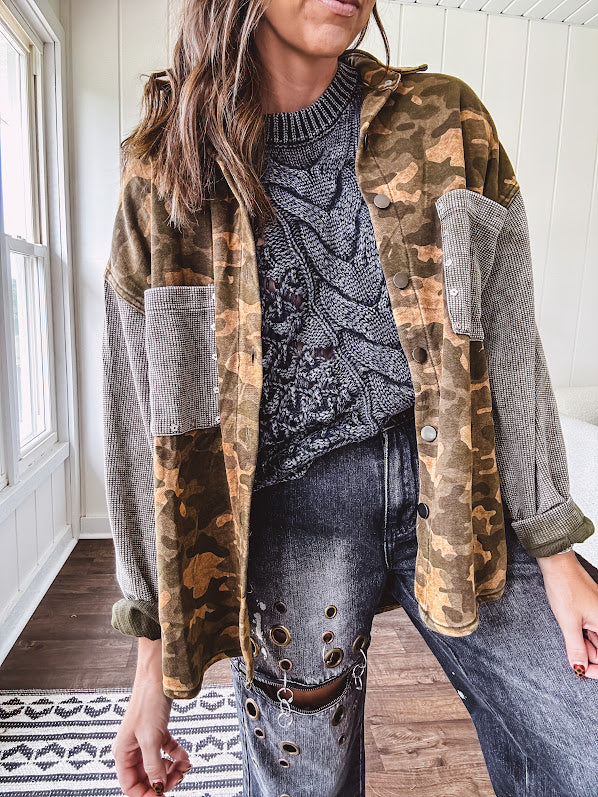Lightweight button front camo jacket with olive and mustard colorway textured waffle weave on the sleeves and pockets, collar, metal buttons and tiny floral rivets throughout.