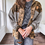 Lightweight button front camo jacket with olive and mustard colorway textured waffle weave on the sleeves and pockets, collar, metal buttons and tiny floral rivets throughout.