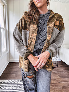 Lightweight button front camo jacket with olive and mustard colorway textured waffle weave on the sleeves and pockets, collar, metal buttons and tiny floral rivets throughout.
