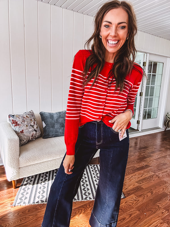 Lightweight red and pink horizontal striped button down long sleeved cardigan.