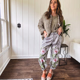 Lightweight washed black joggers with elastic back, floral button down closure and pink and green oversized floral embroidery down the front of both legs.