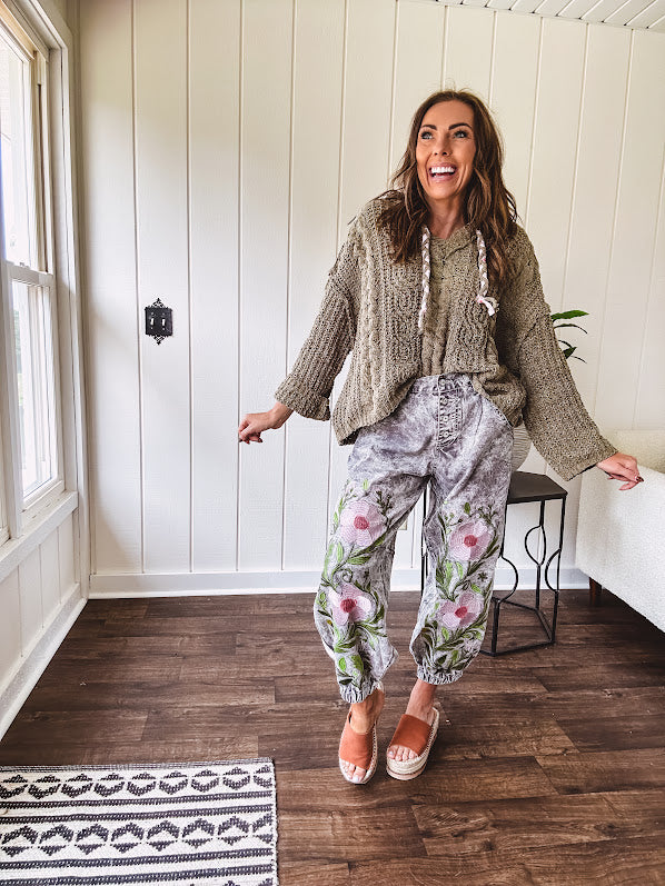 Chenille-like woven long sleeved sweater in light olive green with hoodie and matching rope ties with relaxed hem and fit.