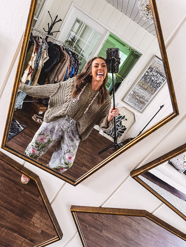 Lightweight washed black joggers with elastic back, floral button down closure and pink and green oversized floral embroidery down the front of both legs.