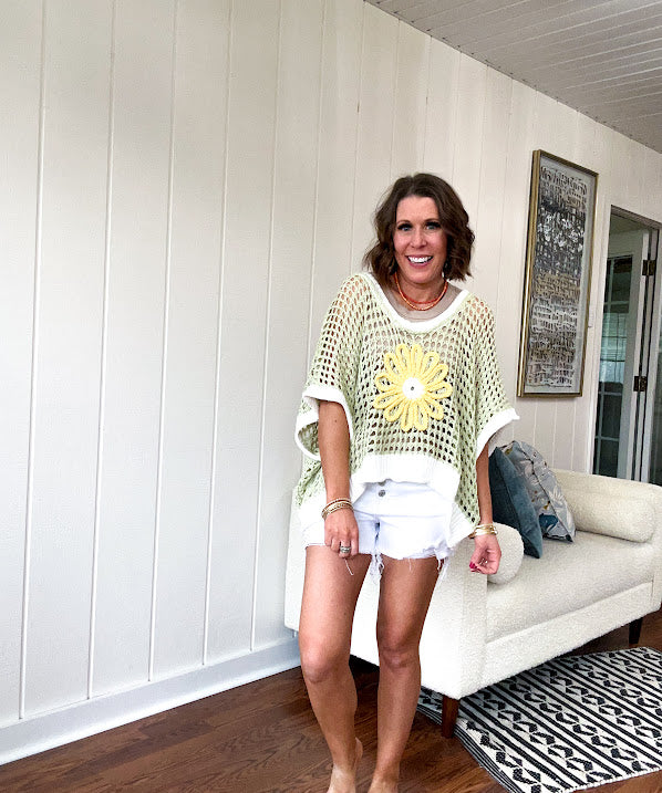 Open weave crochet sweater with 3/4 sleeves and large contrasting crochet flower on the front and contrasting trim. Oversized. Available in multiple colors.