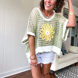 Open weave crochet sweater with 3/4 sleeves and large contrasting crochet flower on the front and contrasting trim. Oversized. Available in multiple colors.
