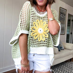 Open weave crochet sweater with 3/4 sleeves and large contrasting crochet flower on the front and contrasting trim. Oversized. Available in multiple colors.