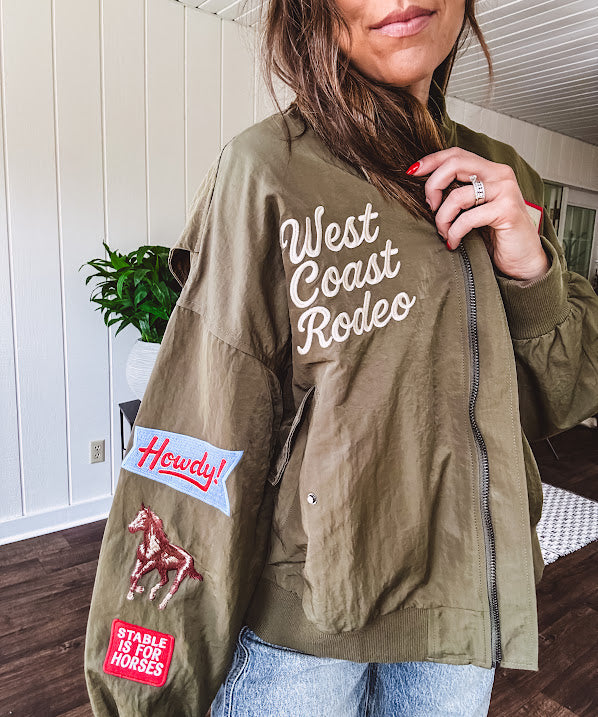 Olive classic bomber jacket with western inspired patchwork and embroidery throughout with zip up front and elastic waist, collar and cuffs.