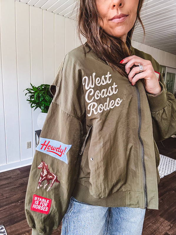 Olive classic bomber jacket with western inspired patchwork and embroidery throughout with zip up front and elastic waist, collar and cuffs.