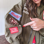 Olive classic bomber jacket with western inspired patchwork and embroidery throughout with zip up front and elastic waist, collar and cuffs.