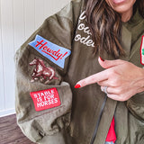 Olive classic bomber jacket with western inspired patchwork and embroidery throughout with zip up front and elastic waist, collar and cuffs.