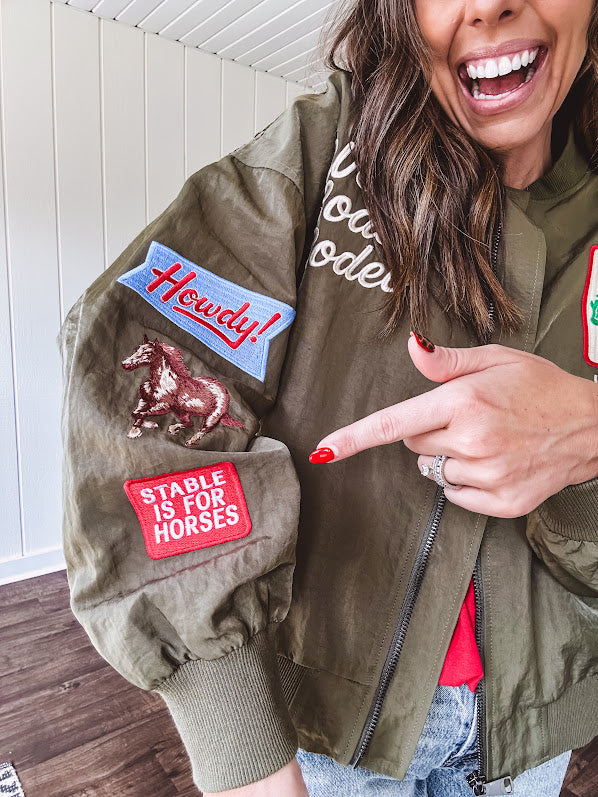 Olive classic bomber jacket with western inspired patchwork and embroidery throughout with zip up front and elastic waist, collar and cuffs.