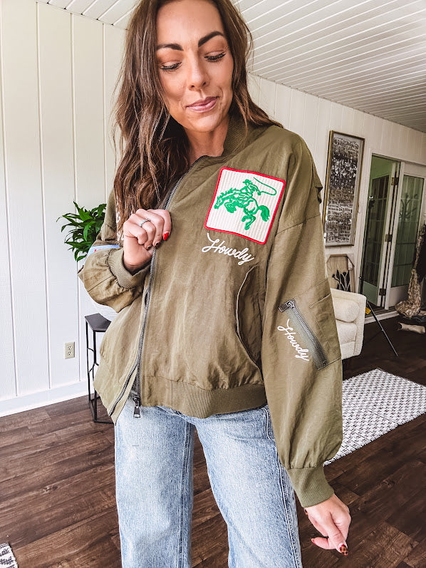 Olive classic bomber jacket with western inspired patchwork and embroidery throughout with zip up front and elastic waist, collar and cuffs.