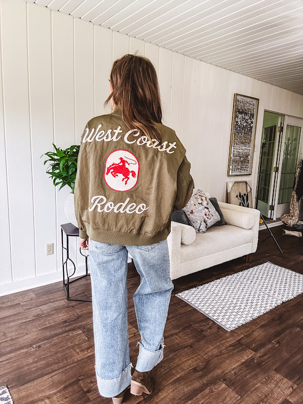 Olive classic bomber jacket with western inspired patchwork and embroidery throughout with zip up front and elastic waist, collar and cuffs.
