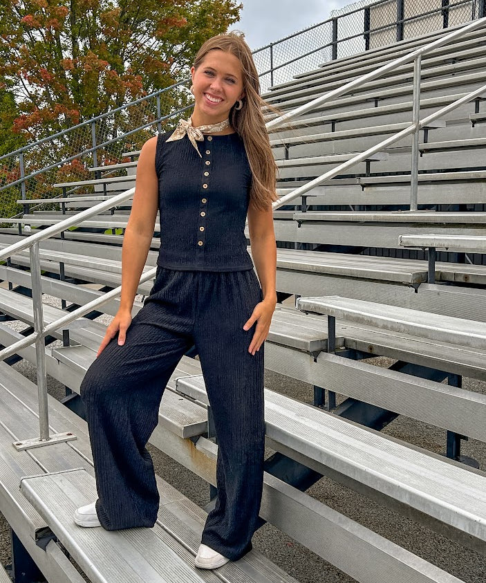 Textured black knit sleeveless top with wooden buttons down the front.