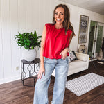 Cool red cotton blend bubble hem blouse tank with padded shoulders with shoulder pleats and round neck.