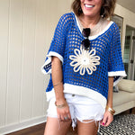 Open weave crochet sweater with 3/4 sleeves and large contrasting crochet flower on the front and contrasting trim. Oversized. Available in multiple colors.
