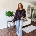 Black long sleeved blouse with lace and eyelet ruffle detail throughout.