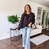 Black long sleeved blouse with lace and eyelet ruffle detail throughout.