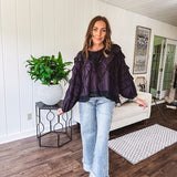 Black long sleeved blouse with lace and eyelet ruffle detail throughout.