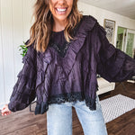 Black long sleeved blouse with lace and eyelet ruffle detail throughout.
