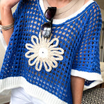 Open weave crochet sweater with 3/4 sleeves and large contrasting crochet flower on the front and contrasting trim. Oversized. Available in multiple colors.