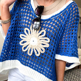 Open weave crochet sweater with 3/4 sleeves and large contrasting crochet flower on the front and contrasting trim. Oversized. Available in multiple colors.