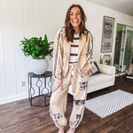 Lightweight, nearly sheet knit sweater with capped sleeves in cream with dark brown stripes and middle front seam detail.